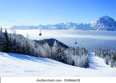 Picture of temperature inversion at Lake Louise, causing a cloud of sea with gondola visible.