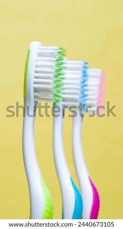 picture of three colorful toothbrushes