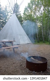 Picture Of A Tipi With Fire Pit And Picnic Table On A Campground In Alberta, Canada.