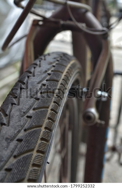 Picture of tire from road bike with v brake as\
blurred background