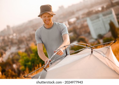 A picture of a toursit pitching the tent