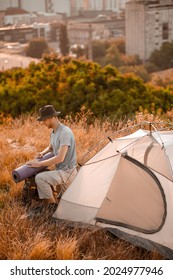 A picture of a toursit pitching the tent