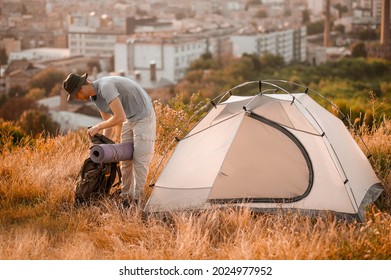 A picture of a toursit pitching the tent