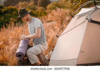 A picture of a toursit pitching the tent