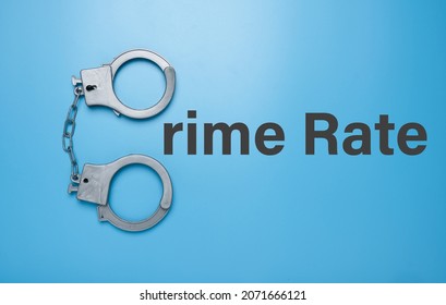 A Picture Of Toy Handcuff With Crime Rate Word.