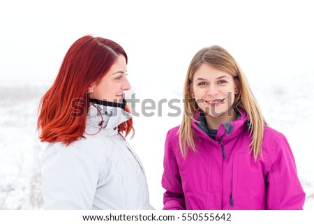 Picture of two beautiful ladies talking a walk outside