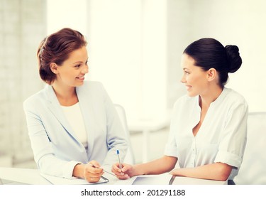 picture of two businesswomen having discussion in office - Shutterstock ID 201291188