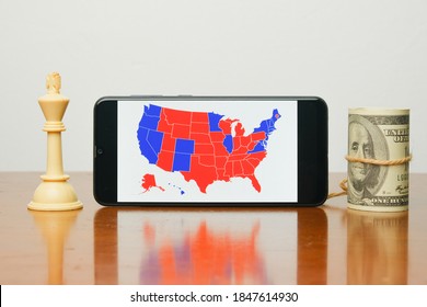 A Picture Of  US Election Map On Smart Phone With White King Chess And Fake Dollar Insight. People Are Waiting The Outcome Of US President 2020 Election.