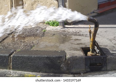 Picture Of A Water Pipe Flushing Operation On The Street. The Water Distribution Network In Large Cities Has Become So Old That It Is Necessary To Constantly Carry Out Repairs And Pipes Flushing.