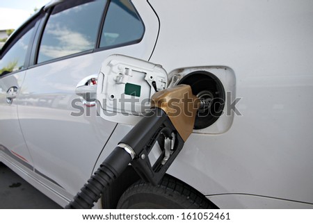 The Picture White cars are fuel filler in Gas station.