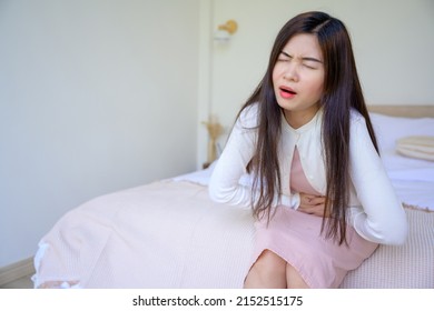 Picture Of A Woman Hugging Her Stomach In Bed Suffering From Severe Abdominal Pain Unhappy Middle Aged Woman Stomach Discomfort Diarrhea From Food Poisoning