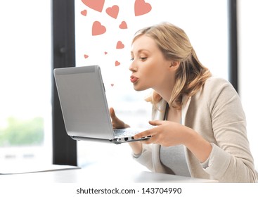 picture of woman with laptop computer sending kisses and hearts