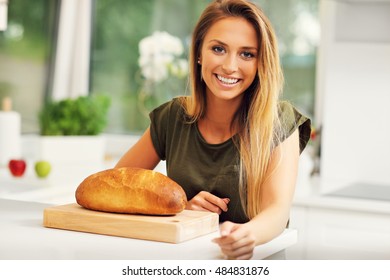 Picture Of Woman With Loaf Of Bread In The Kitchen