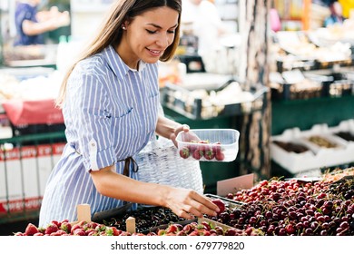 Picture Of Woman At Marketplace Buying Fruits