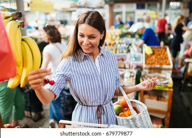 Picture Of Woman At Marketplace Buying Fruits