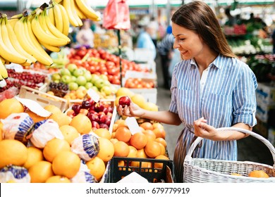 Picture Of Woman At Marketplace Buying Fruits