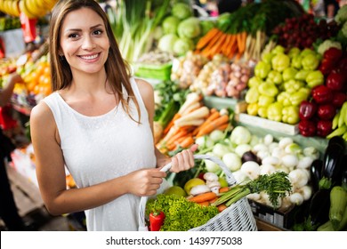 Picture Of Woman At Marketplace Buying Vegetables