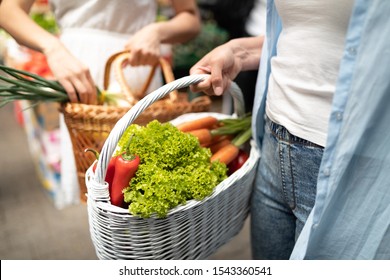 Picture Of Woman At Marketplace Buying Vegetables