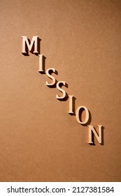 A picture with the words "mission" made of wood. Props related to the mission.