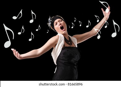 A picture of a young beautiful opera singer performing over black background