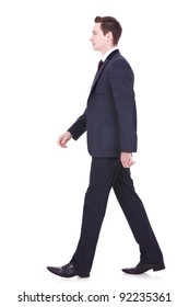 Picture Of A Young Business Man Walking Forward - Side View