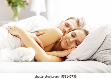 Picture of young couple sleeping in bed