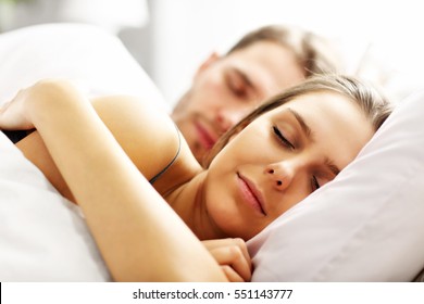 Picture Of Young Couple Sleeping In Bed