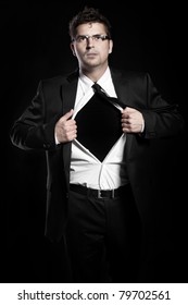 A Picture Of A Young Handsome Man Tearing Off His Shirt Over Black Background