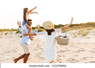 Стоковая фотография: Picture of young happy family having fun together at the beach.