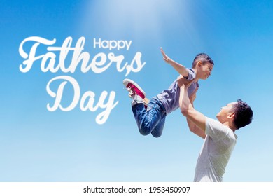 Picture of young man lifting his son while playing together under blue sky with Happy Fathers Day text