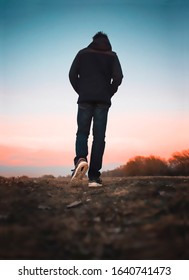 Picture Of Young Man Walking Away In Sneakers. Back View.