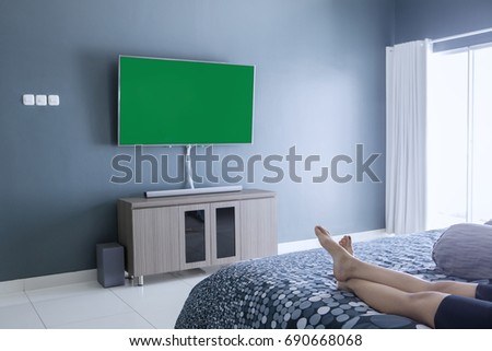 Picture of young woman foots lying on the bed while enjoying her leisure time in the bedroom
