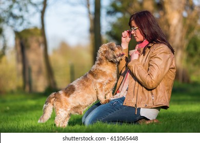 Picture Of A Young Woman Giving Her Dog A Treat