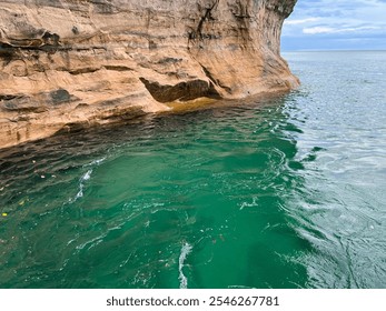 Pictured Rocks National Lakeshore Beautiful Scenic Views from the Water Lake Superior with Erosion, Sandstone Cliffs, Beaches, Waterfalls, Deep Forest, and Wild Shoreline with Clear Serene Water. - Powered by Shutterstock