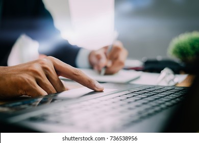 Pictures of businessman that operate on the table being checking data office desk background and writing note on wood table, Concept to checklist.