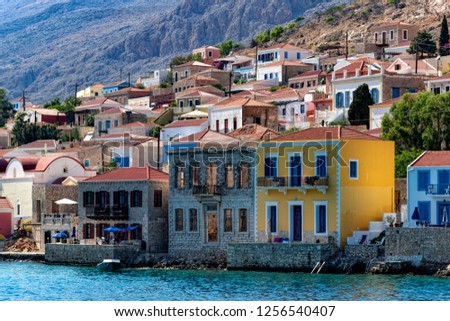 Picturescue colorful houses on embankment of Chalki Island, one of the Dodecanese islands of Greece, close to Rhodes.
