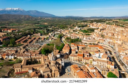 Picturesque Aerial View Of Tarazona Cityscape On Banks Of Queiles River Overlooking Ancient Cathedral And Bullring With Snow-capped Moncayo Mountain Range In Background In Spring, Spain