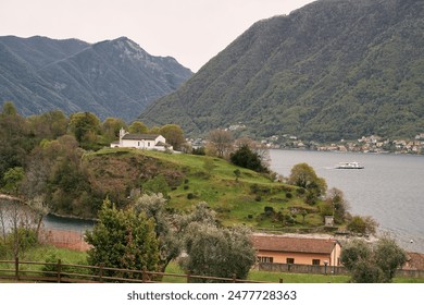 Picturesque alpine lakeside town with snow-capped mountains and boats - Powered by Shutterstock