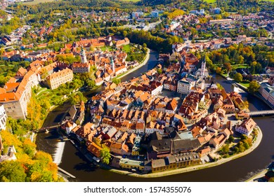 Picturesque autumn cityscape of Cesky Krumlov overlooking its historic centre around ancient Castle on bank of Vltava river, Czech Republic