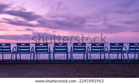 Picturesque blues chairs on the Promenade des Anglais in Nice on the French Riviera