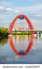 picturesque bridge over the Moscow river with reflection in the water. Unique suspension bridge in Moscow. blurry part - Shutterstock ID 2166331879