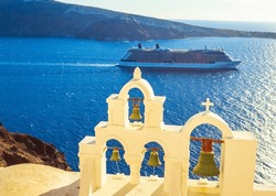 Picturesque Clifftop View From Unique Oia Town With Traditional Church Belfry ,sailing Cruise Ship In Caldera And Therasia Island In The Opposite.town Has Whitewashed Houses Carved, Enthralling Sunset