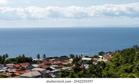 picturesque coastal town with colorful houses and palm trees, overlooking a vast blue ocean. - Powered by Shutterstock