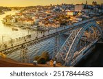 Picturesque, colorful view at old town Porto with famous bridge at night, Portugal with bridge Ponte Dom Luis over Douro river. Oporto, touristic mediterranean city