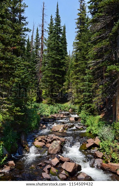 picturesque creek\
and boulders along the hiking trail to blue lake, in the indian\
peaks wilderness area,\
colorado
