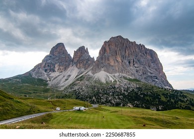 Picturesque huge mountains of the Italian Alps in the Dolomites, Val Gardena, Sella Pass, Sassolungo. Ideal travel destination for motorhome trips and roadtrips. Impressive alpine mountain pass.
