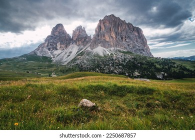 Picturesque huge mountains of the Italian alps in the Dolomites, Val Gardena, Sella Pass, Langkofel, Sassolungo. Ideal travel destination for roadtrip or motorcycle trip. Alpine stunning landscape.