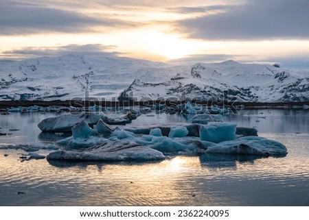 Picturesque icebergs floating in the Jökulsárlón glacier lagoon at dusk, the evening sun reflected in the water, Vatnajökull National Park, Ring Road  Route 1, Iceland