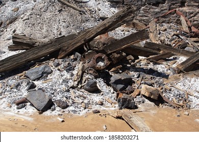 Picturesque Jumble Of  Pipe, Stones And Burnt Wood Debris On The Edge Of A Mullock Heap