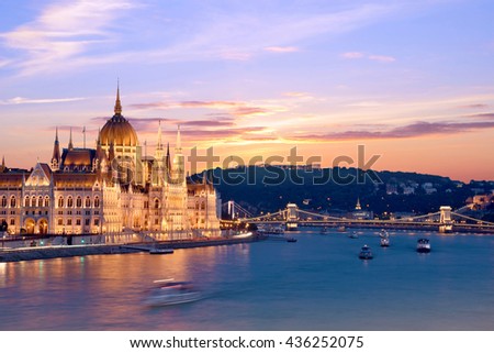 The picturesque landscape of the Parliament and the bridge over the Danube in Budapest, Hungary, Europe at sunset